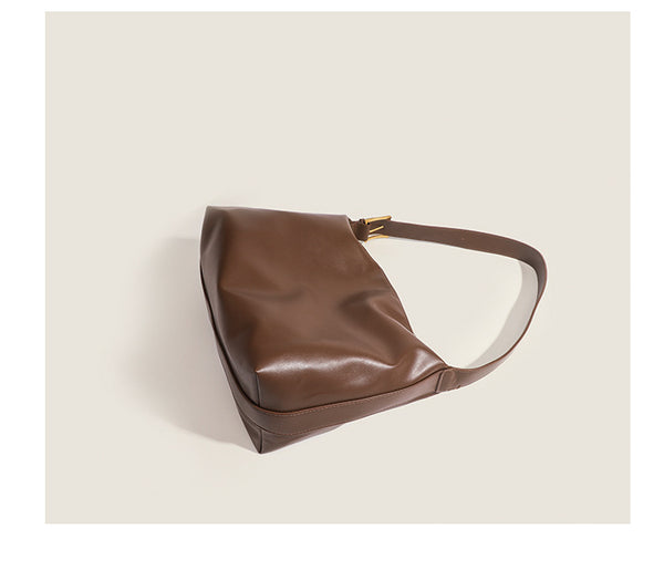 Large slouchy hobo shoulder bag in smooth leather-look finish with single long strap and gold-tone zip closure, detail view