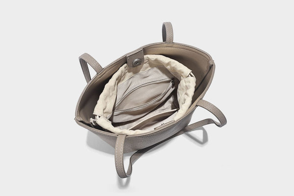 Structured pebbled leather-look tote bag in taupe with long shoulder strap, detachable zip pouch, and pink tulip flower