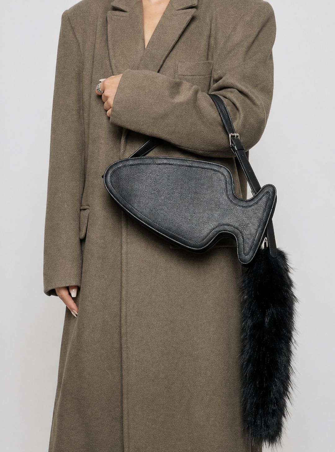 Fish-shaped pebbled leather-look crossbody bag with black faux-fur tail accent and adjustable shoulder strap, detail view 8
