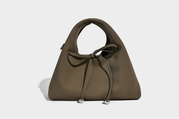 Pebbled matte trapezoid top-handle bag with drawstring bow closure, bead-tipped cords, silver-tone hardware, and detachable