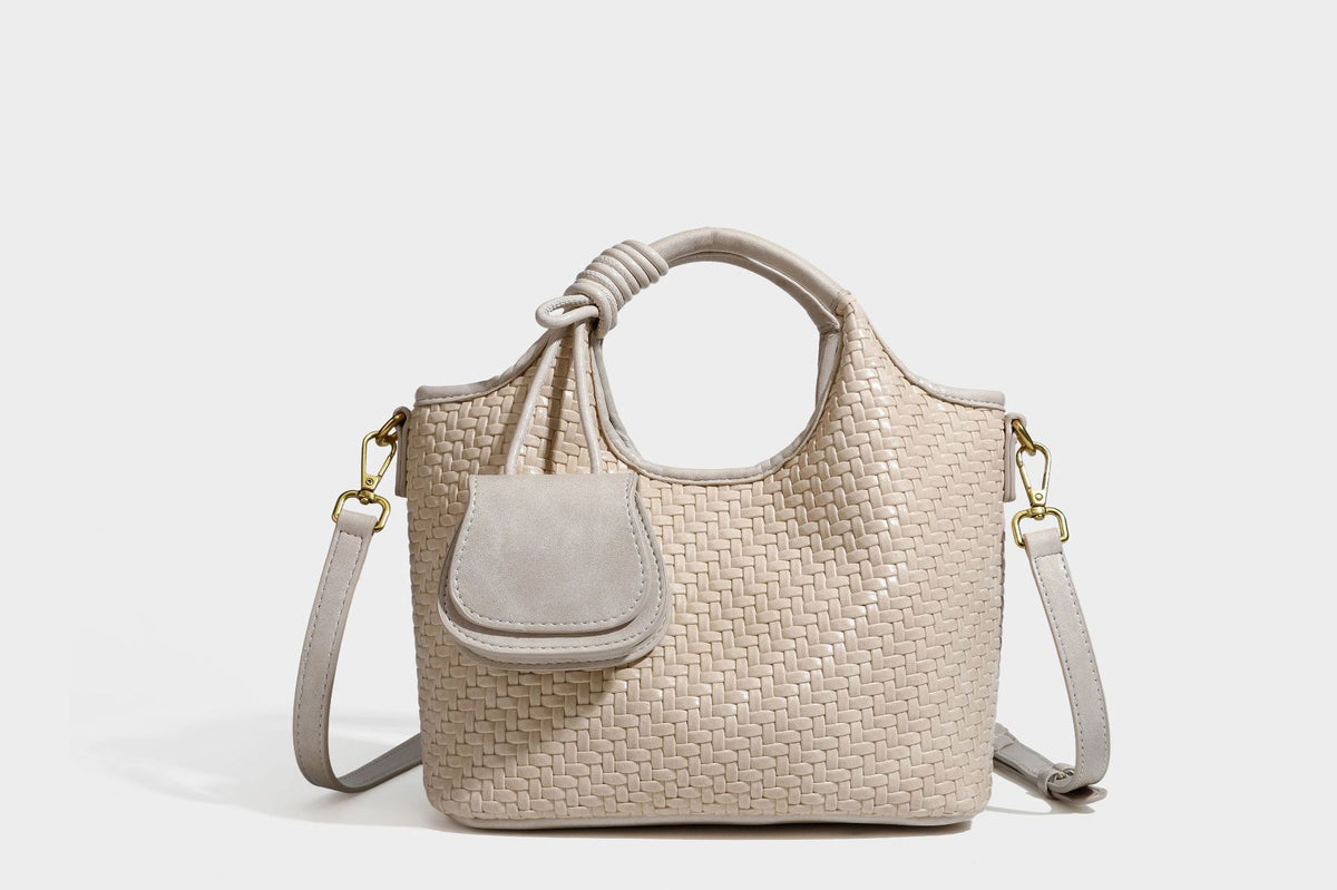 Woven leather-look tote bag in mocha brown with knotted top handle, front flap pocket, and detachable crossbody strap with