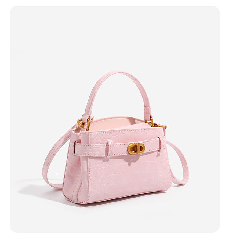 Small structured crocodile-embossed top-handle bag with gold-tone turn-lock closure and detachable shoulder strap, detail