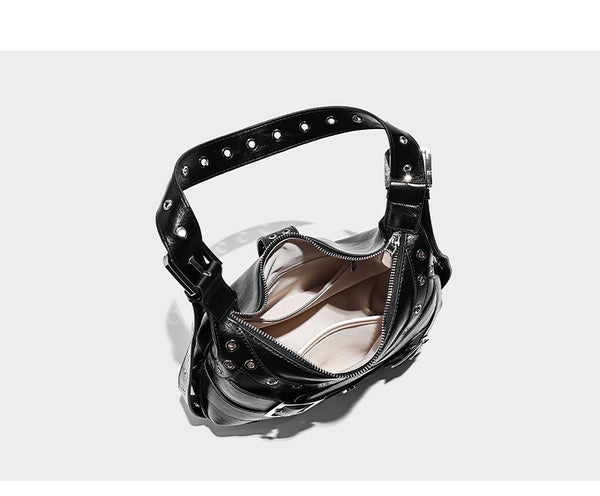 Glossy crescent hobo bag with silver-tone grommets, square buckle straps, and top zipper closure, detail view 7