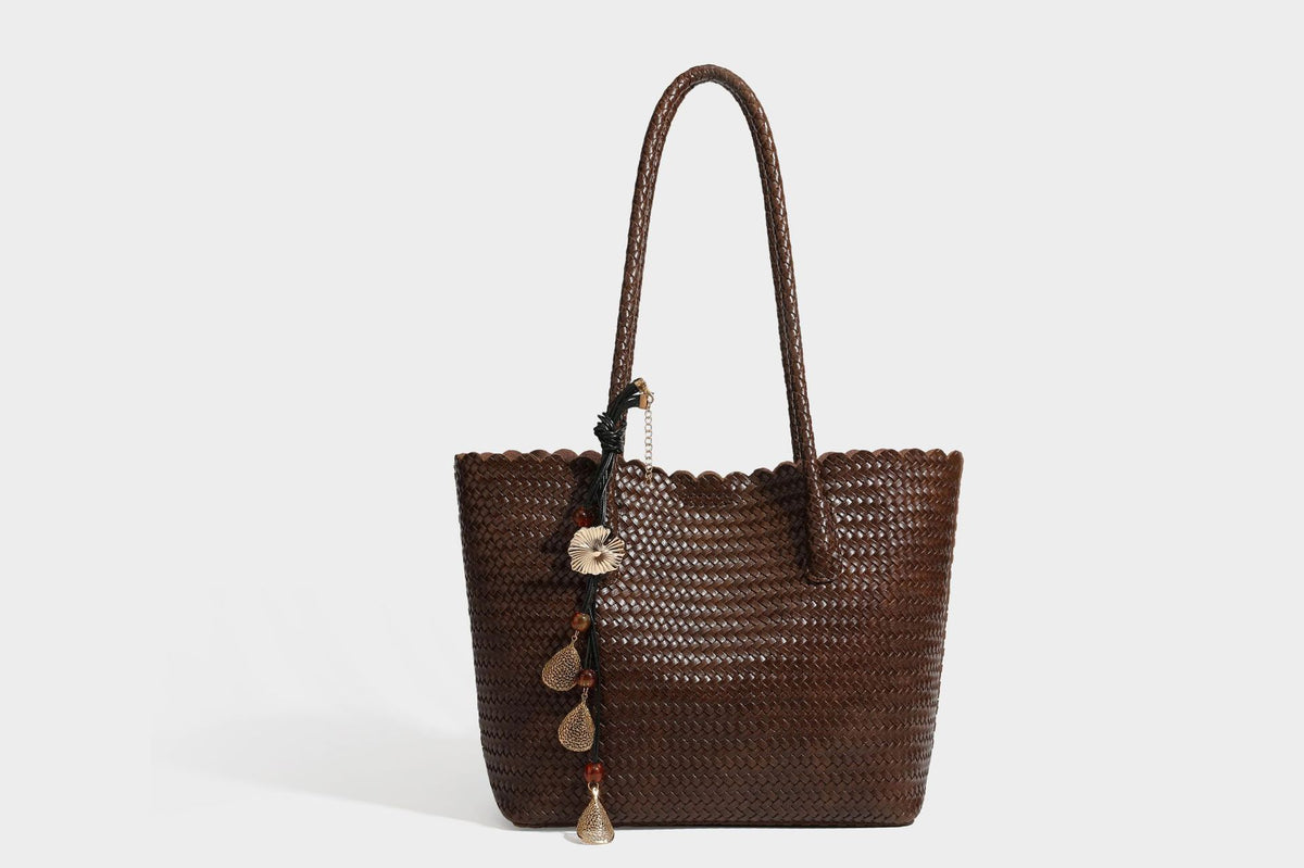 Large open-top woven leather-look tote bag in dark brown with scalloped edge, braided double shoulder straps, and decorative
