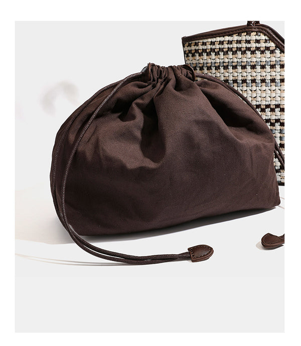 Large woven checker-pattern tote bag with dark braided shoulder straps, leather-look trim, and drawstring side ties, detail