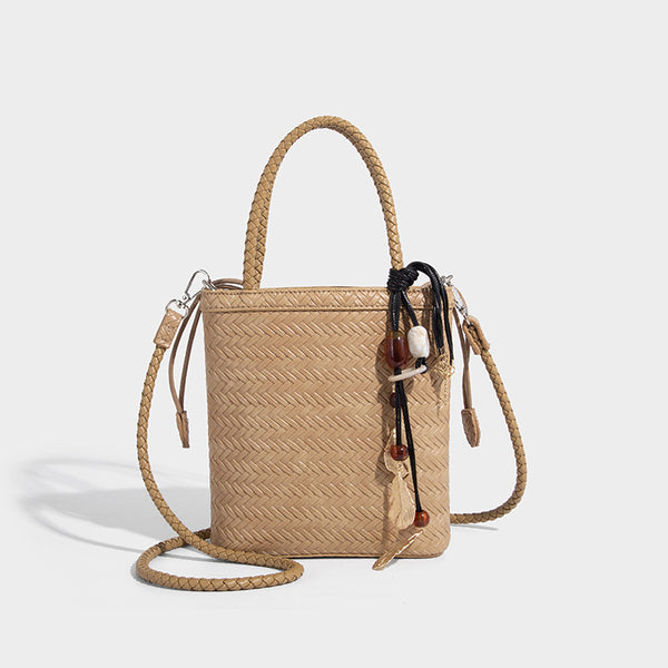 Small structured woven-texture tote bag with braided top handles and drawstring inner pouch, detail view 11