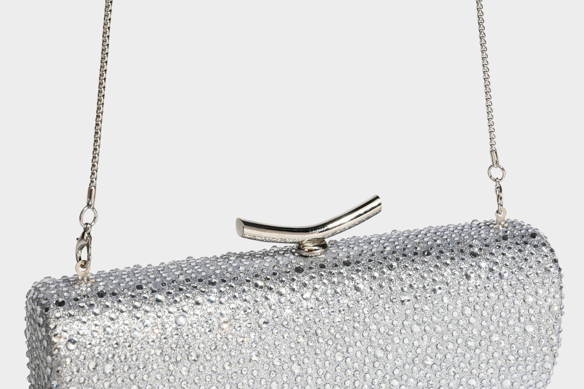 Structured rectangular hard-case clutch bag covered in all-over rhinestone crystal embellishment with curved kiss-lock top