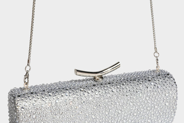 Structured rectangular hard-case clutch bag covered in all-over rhinestone crystal embellishment with curved kiss-lock top