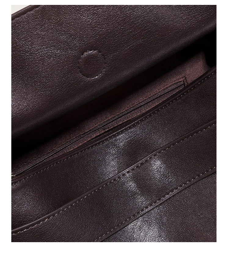 Structured rectangular flap shoulder bag in dark brown leather-look finish with long single strap and layered front panel