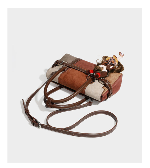 Structured color-block satchel bag in brown, rust, beige, and taupe suede-look panels with white topstitching, front buckle
