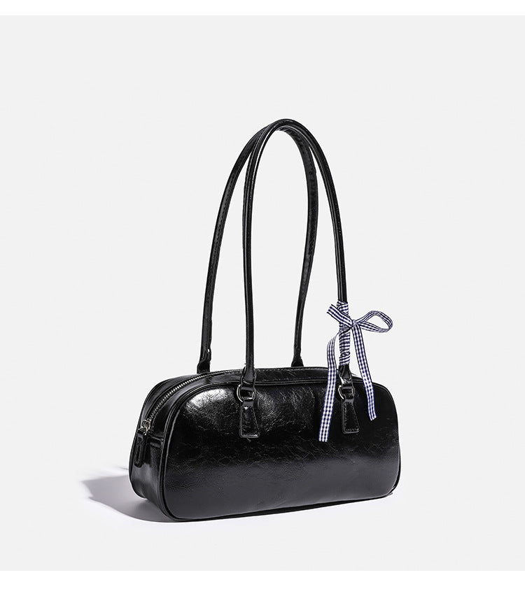 Rounded rectangular shoulder bag with glossy crinkled finish, dual long handles, top zip closure, and gingham ribbon bow