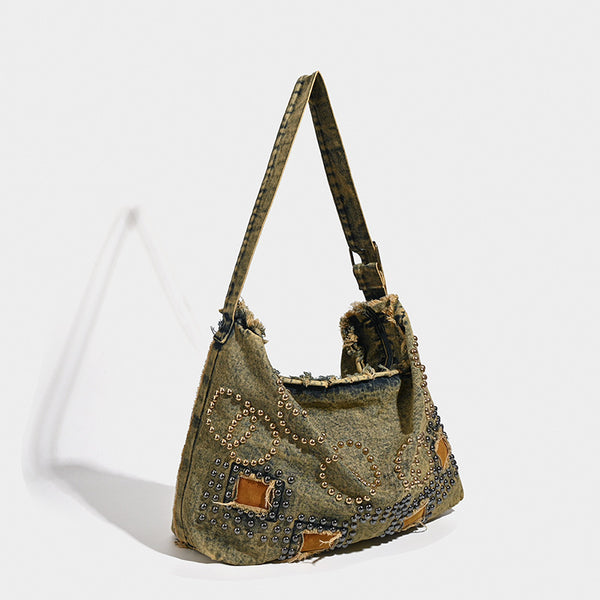 Large distressed denim hobo shoulder bag with mixed-metal rivet detailing and tan leather-look corner trim, detail view 2