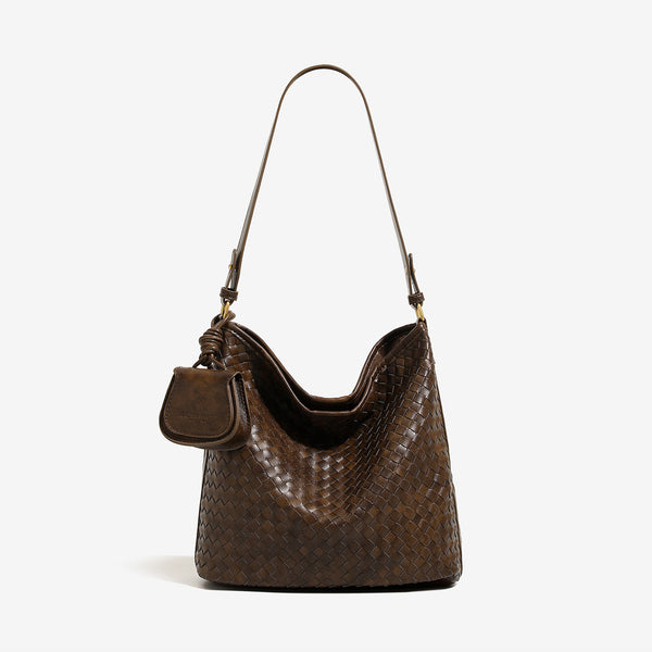 Dark brown woven leather-look bucket shoulder bag with mini pouch charm and gold-tone hardware, front view