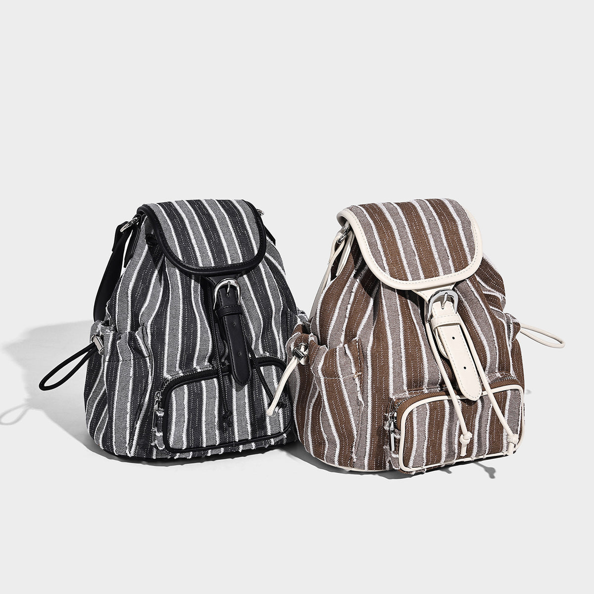 Soft woven vertical-stripe drawstring backpack with flap top, front zip pocket, white leather-look trim and straps, detail