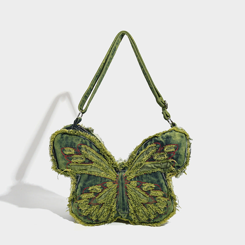 Butterfly-shaped distressed denim shoulder bag with frayed raw edges and embroidered wing panels, detail view 7