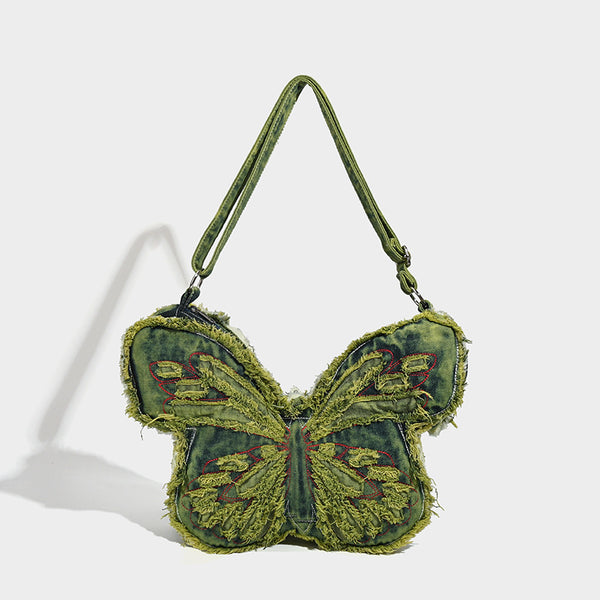 Butterfly-shaped distressed denim shoulder bag with frayed raw edges and embroidered wing panels, detail view 7