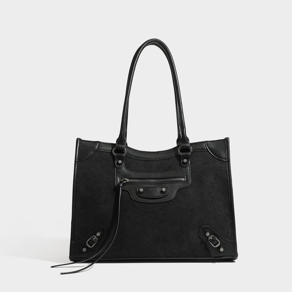Large structured tote bag with matte suede-like body, smooth leather-look trim, front zip pocket, stud hardware, and