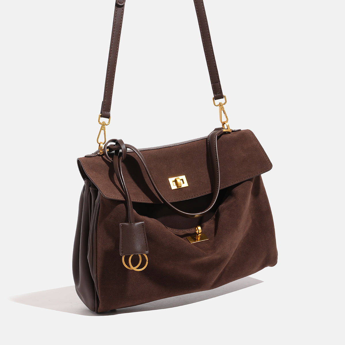 Brown suede-finish structured satchel tote bag with gold-tone turn-lock closure, top handle, and detachable shoulder strap