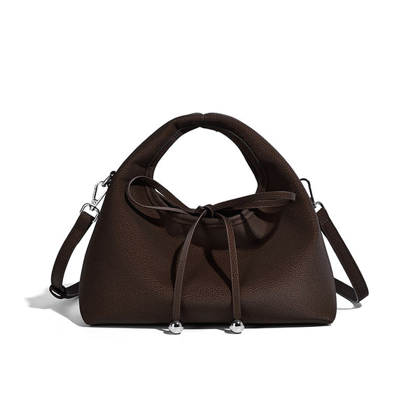 Pebbled matte trapezoid top-handle bag with drawstring bow closure, bead-tipped cords, silver-tone hardware, and detachable