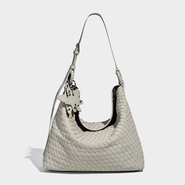 Large soft woven hobo shoulder bag with matte textured finish, adjustable strap, and star charm hardware, detail view 9