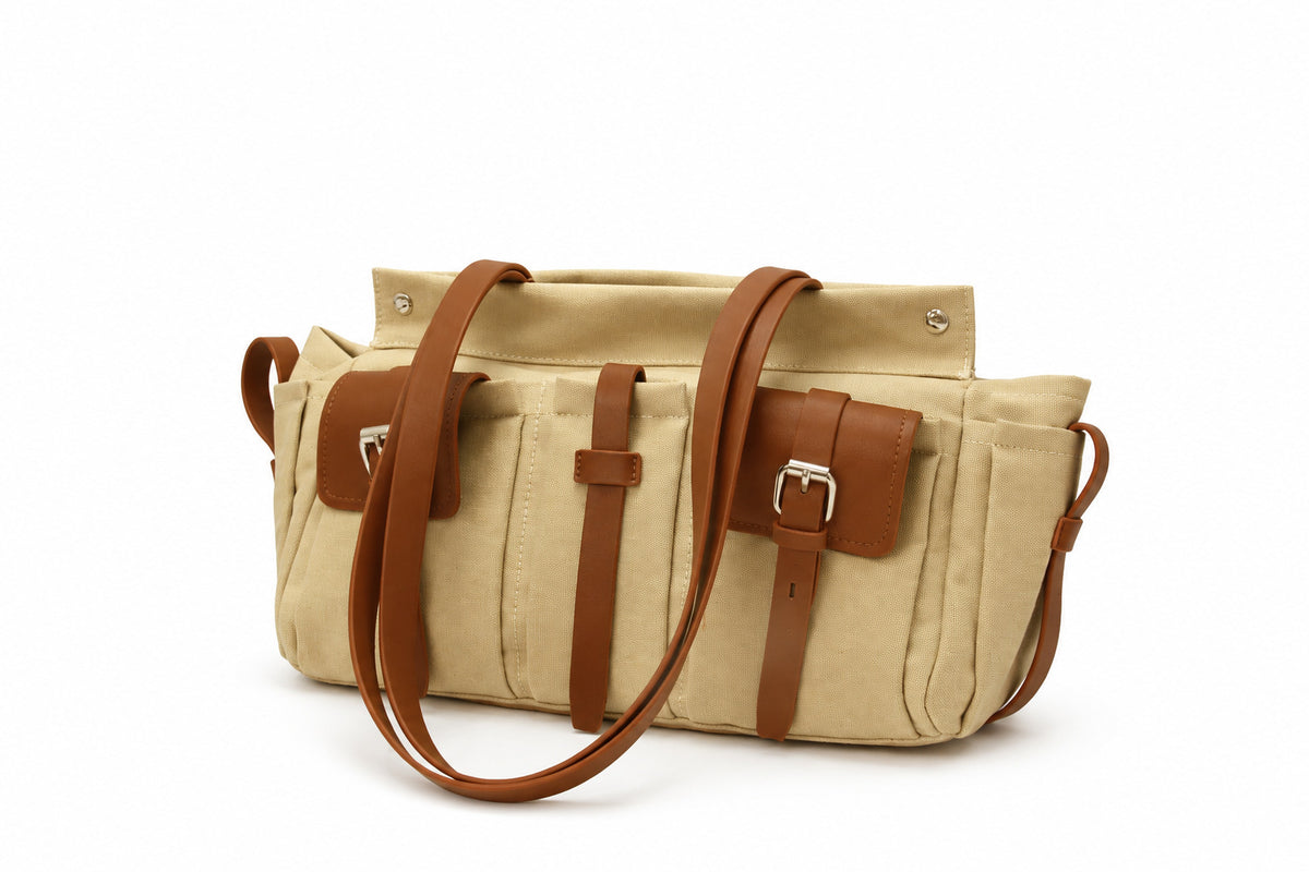 Large olive canvas shoulder tote bag with multiple front buckle-strap pockets and dark brown leather-look trim, detail view 9