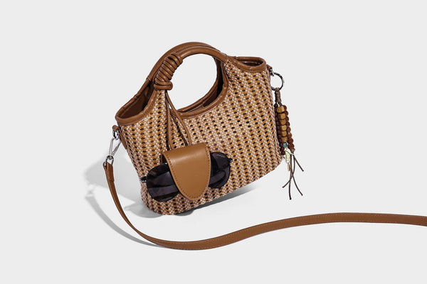 Small structured woven tote crossbody bag with ring top handle, leather-look brown trim, front patch pocket, and detachable