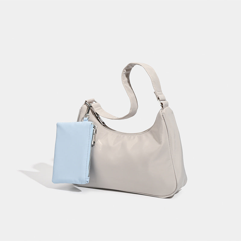 Curved hobo shoulder bag with detachable zip pouch in matte-satin finish with silver-tone hardware, detail view 3