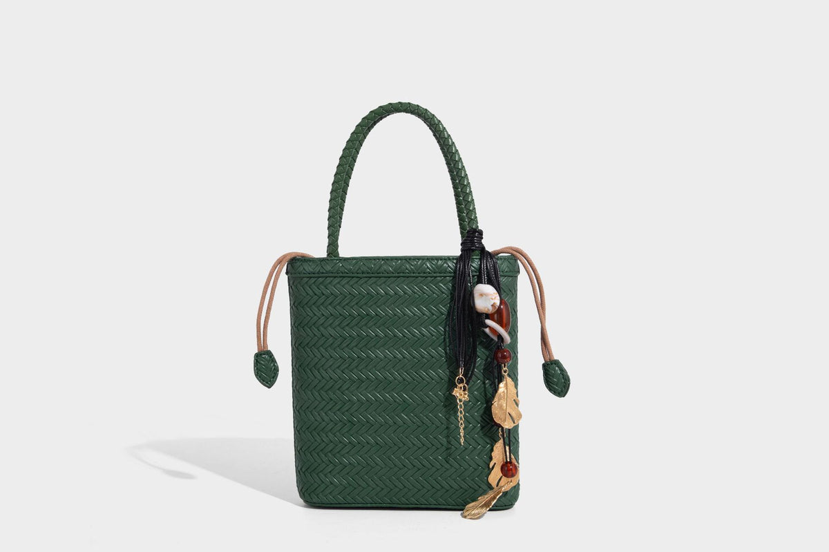 Small structured woven-texture tote bag with braided top handles and drawstring inner pouch, detail view 19