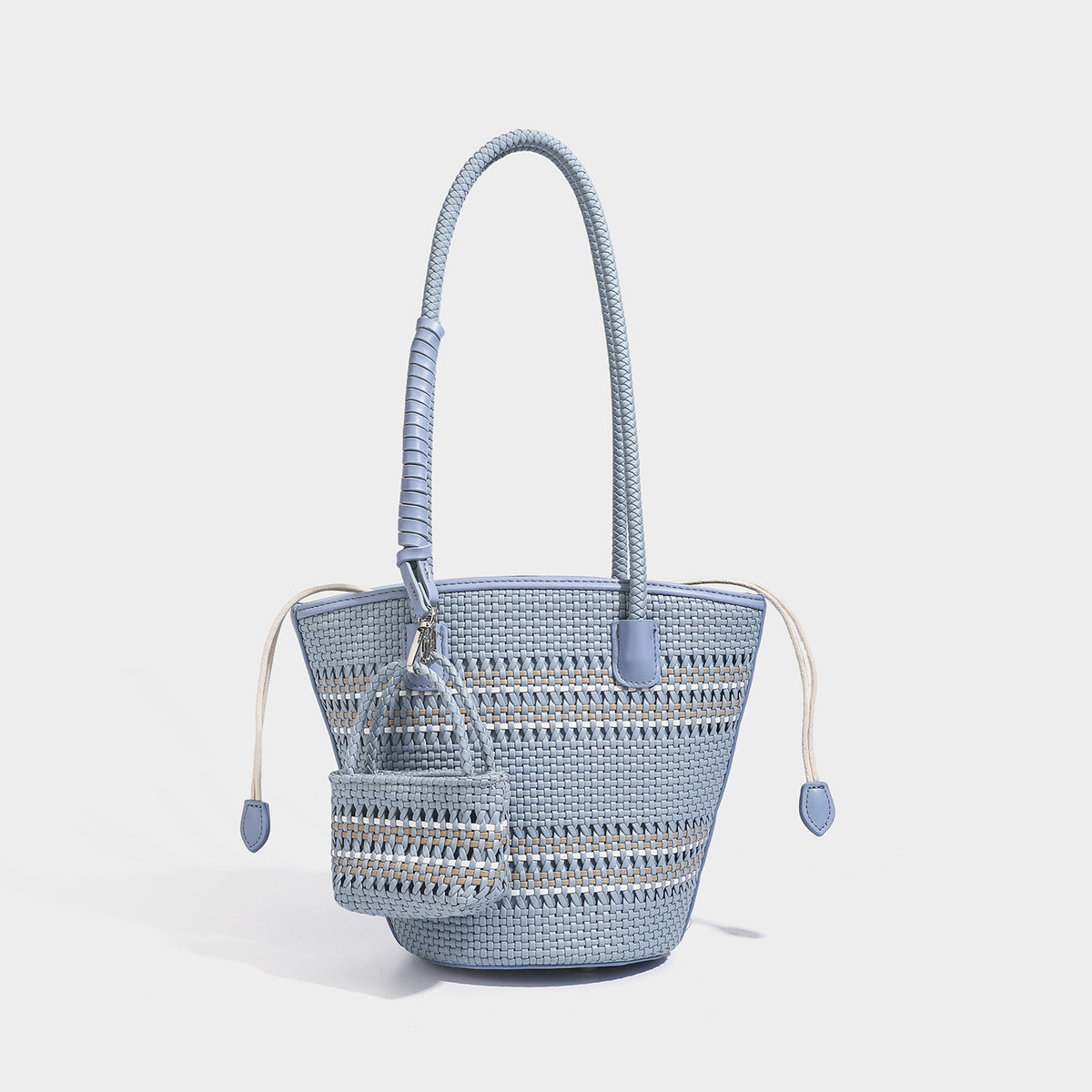 Structured woven bucket tote bag in pastel blue with braided shoulder strap, open lattice weave body, cream drawstring