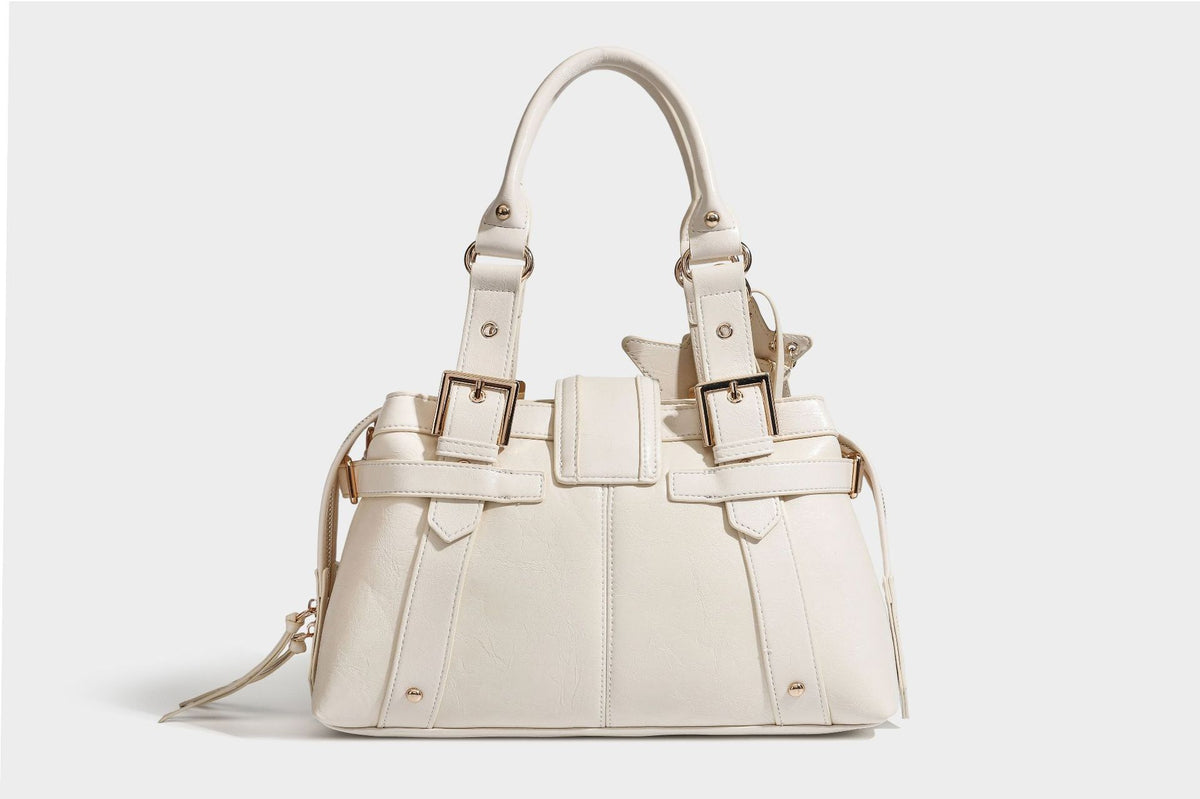 Structured leather-look satchel bag with heart padlock charm, star charm, gold-tone buckle hardware, dual top handles, and