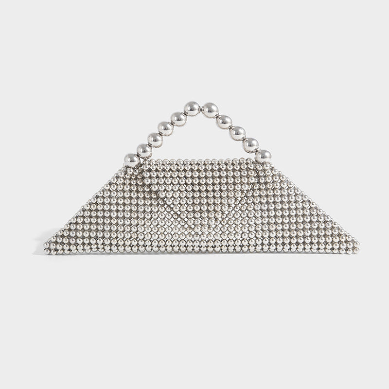 Small structured triangle clutch bag covered in glossy pearl beads with an arched pearl top handle and silver snap closure