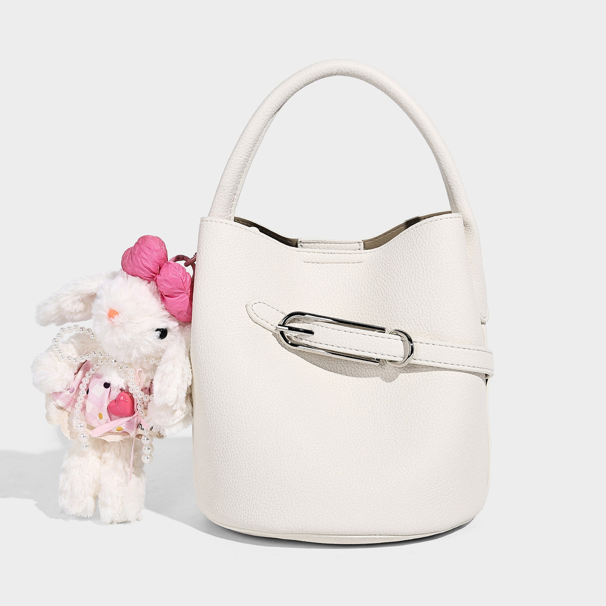 Mini pebbled leather-look bucket bag with front buckle strap, silver-tone hardware, top handle, and detachable shoulder