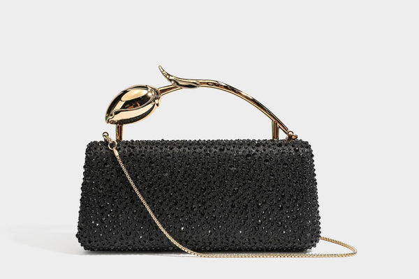 rectangular hard-case rhinestone evening clutch with sculptural gold-tone branch-and-bud top handle and detachable chain