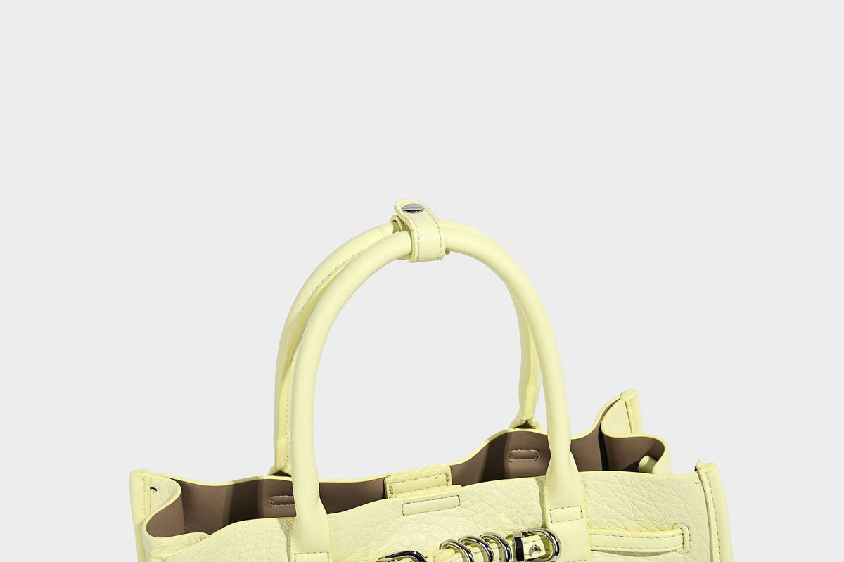 Structured trapezoid tote bag in pebbled leather-look finish with double top handles, silver-tone bar hardware, and, detail