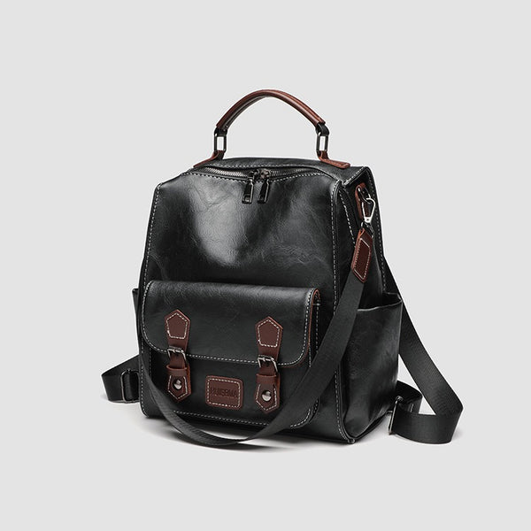 Structured black leather-look convertible backpack handbag with brown contrast trim, buckle front pocket, double-zip top