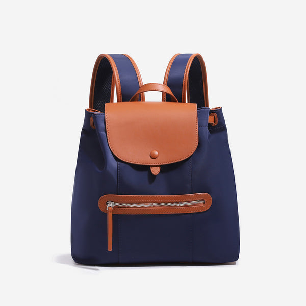 Large flap-top nylon backpack with leather-look trim, snap closure, front zip pocket, and padded shoulder straps, detail view