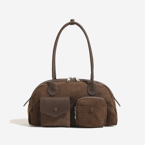 Structured retro bowling-style top-handle handbag with dual zip closure, front snap-flap pocket, and front zip pocket, detail