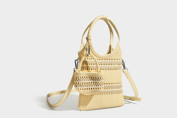 Color-block woven tote bag with rounded leather-look handles, detachable crossbody strap, and matching mini clip-on pouch in