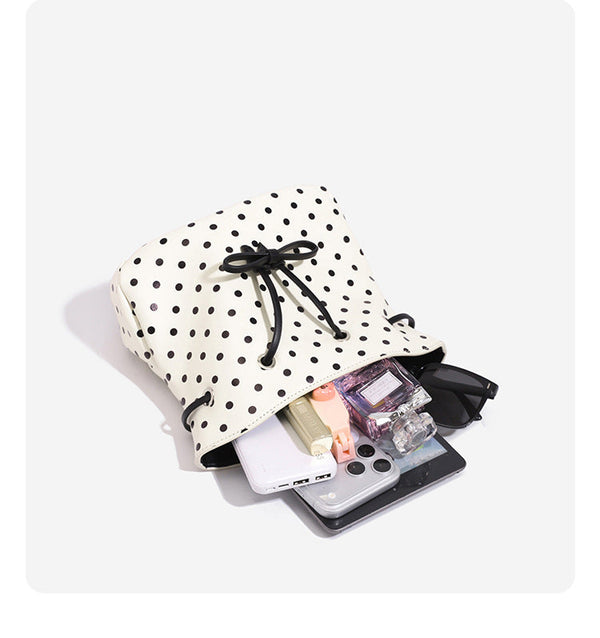 Compact polka-dot drawstring bucket bag with bow closure and rigid top handle, detail view 11