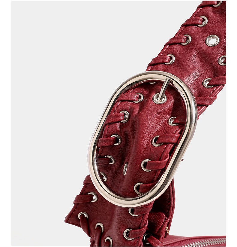 Slouchy hobo shoulder bag with wide braided eyelet strap, multiple front zip compartments, and silver-tone ring buckle