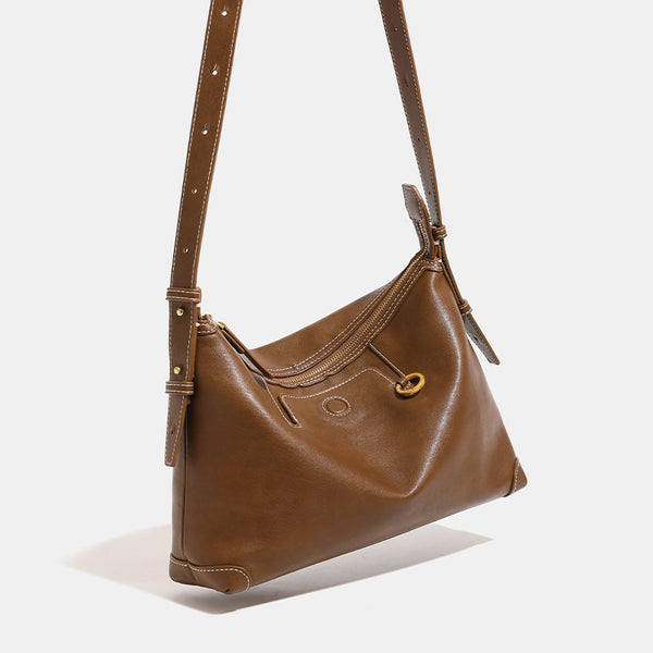 Smooth leather-look hobo bag with gold-tone ring hardware, contrast stitching, top handle and adjustable crossbody strap