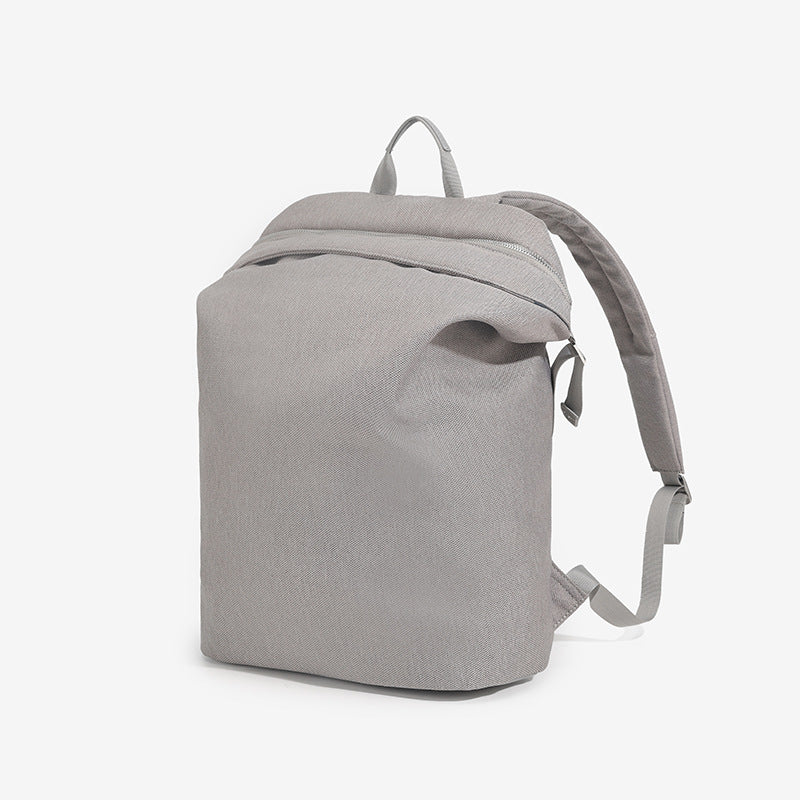 Structured matte nylon backpack with top zip closure, front zip pocket, top carry handle, and adjustable shoulder straps