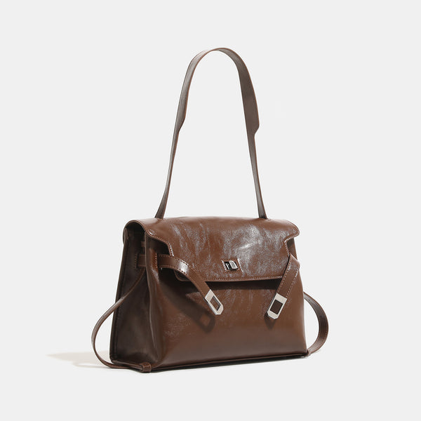 Structured rectangular flap shoulder bag in glossy leather-look finish with silver turn-lock clasp and adjustable strap