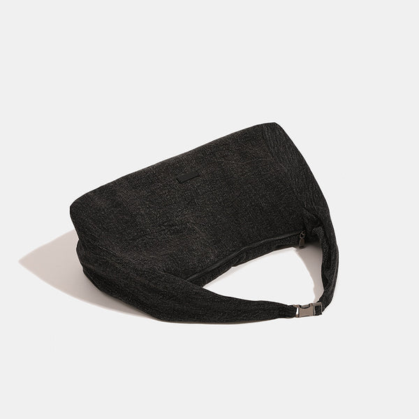 Oversized slouchy hobo shoulder bag in dark marled denim-texture fabric with top zip closure and adjustable single strap