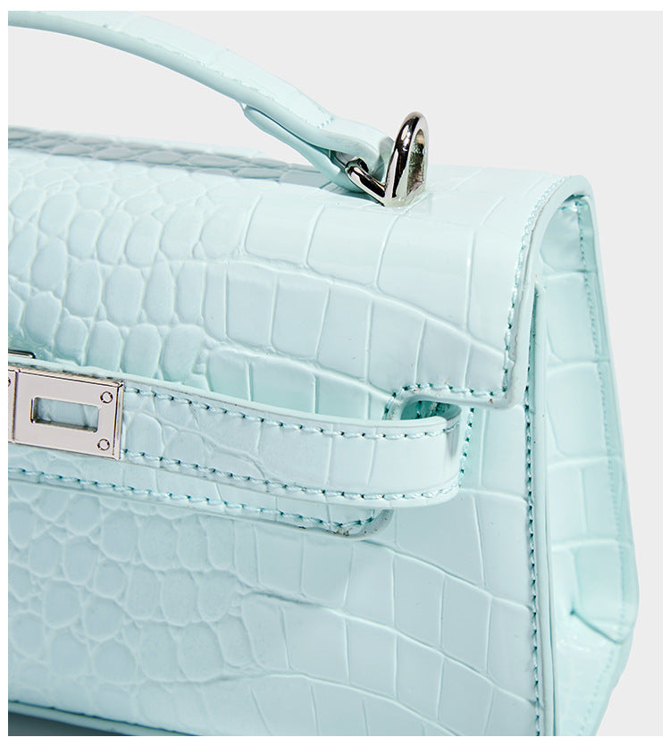 Compact structured flap satchel with glossy crocodile-embossed leather-look finish, silver-tone turn-lock hardware, and