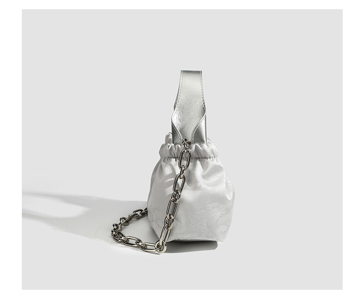Small ruched satin-finish cloud bag with elasticized drawstring top, short top handle, and chunky silver-tone chain strap