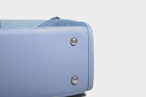 Structured patchwork denim tote bag with frayed panel seams, dual top handles, and silver-tone hardware, detail view 21