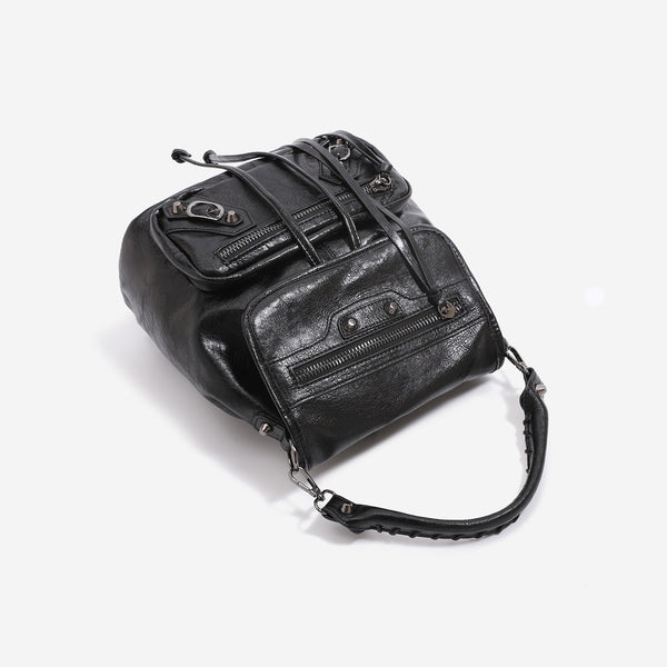 Mini flap backpack handbag with silver stud hardware, front zip pockets, and drawstring tassels, detail view 4