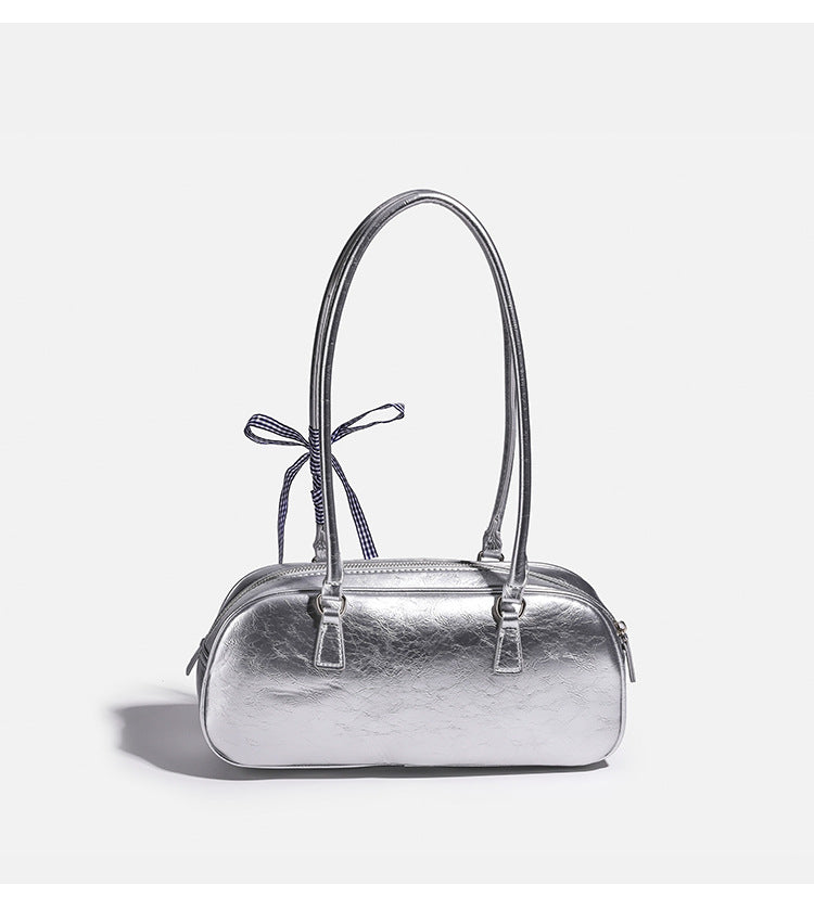 Rounded rectangular shoulder bag with glossy crinkled finish, dual long handles, top zip closure, and gingham ribbon bow
