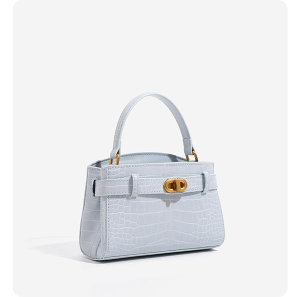 Small structured crocodile-embossed top-handle bag with gold-tone turn-lock closure and detachable shoulder strap, detail